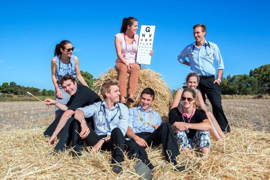 Rural cohort students around a haybale