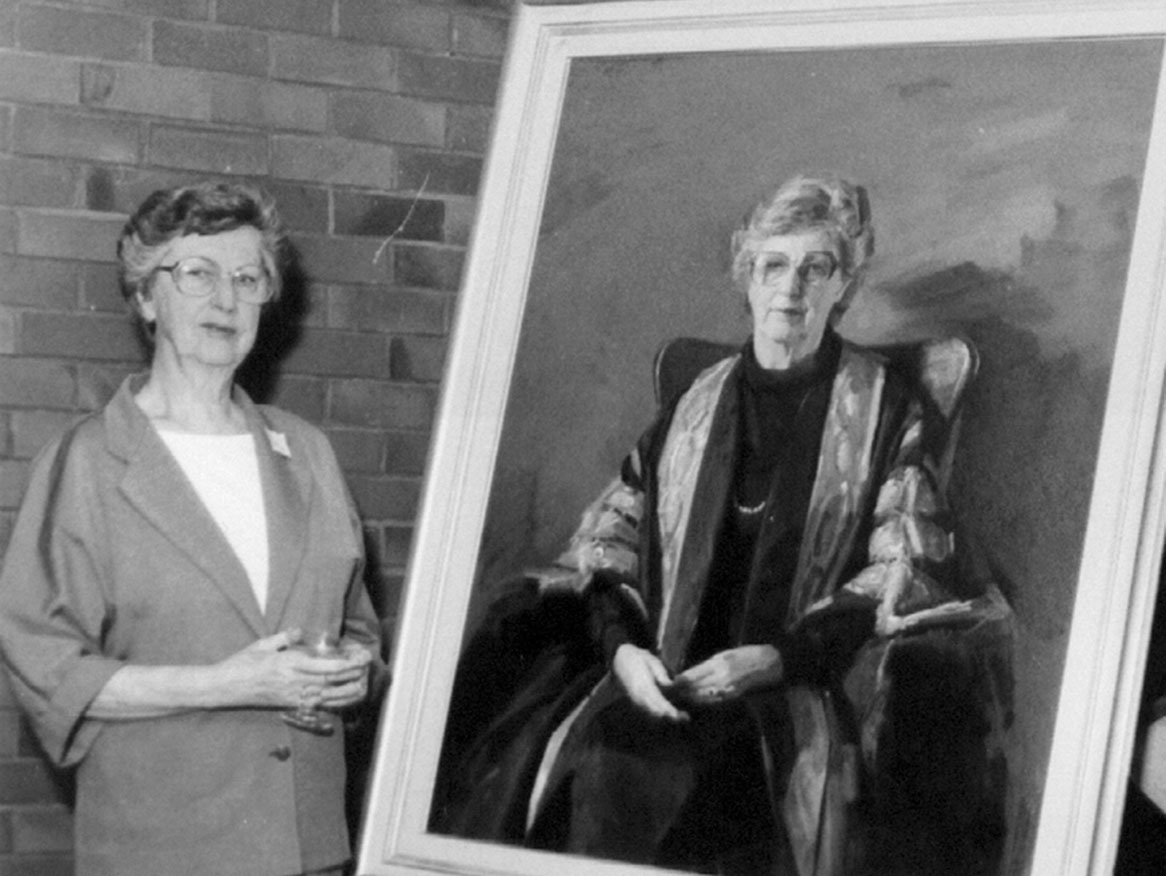 Dame Roma Mitchell alongside a painted portrait.