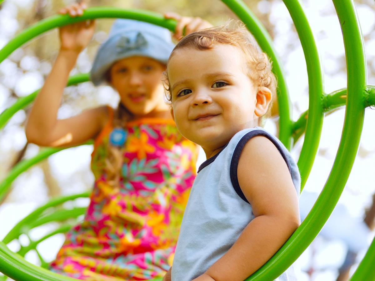 Two children on a playground smiling