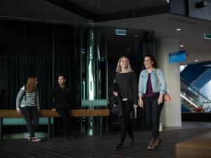 Two students walking through ground floor foyer of Adelaide Health and Medical Sciences building
