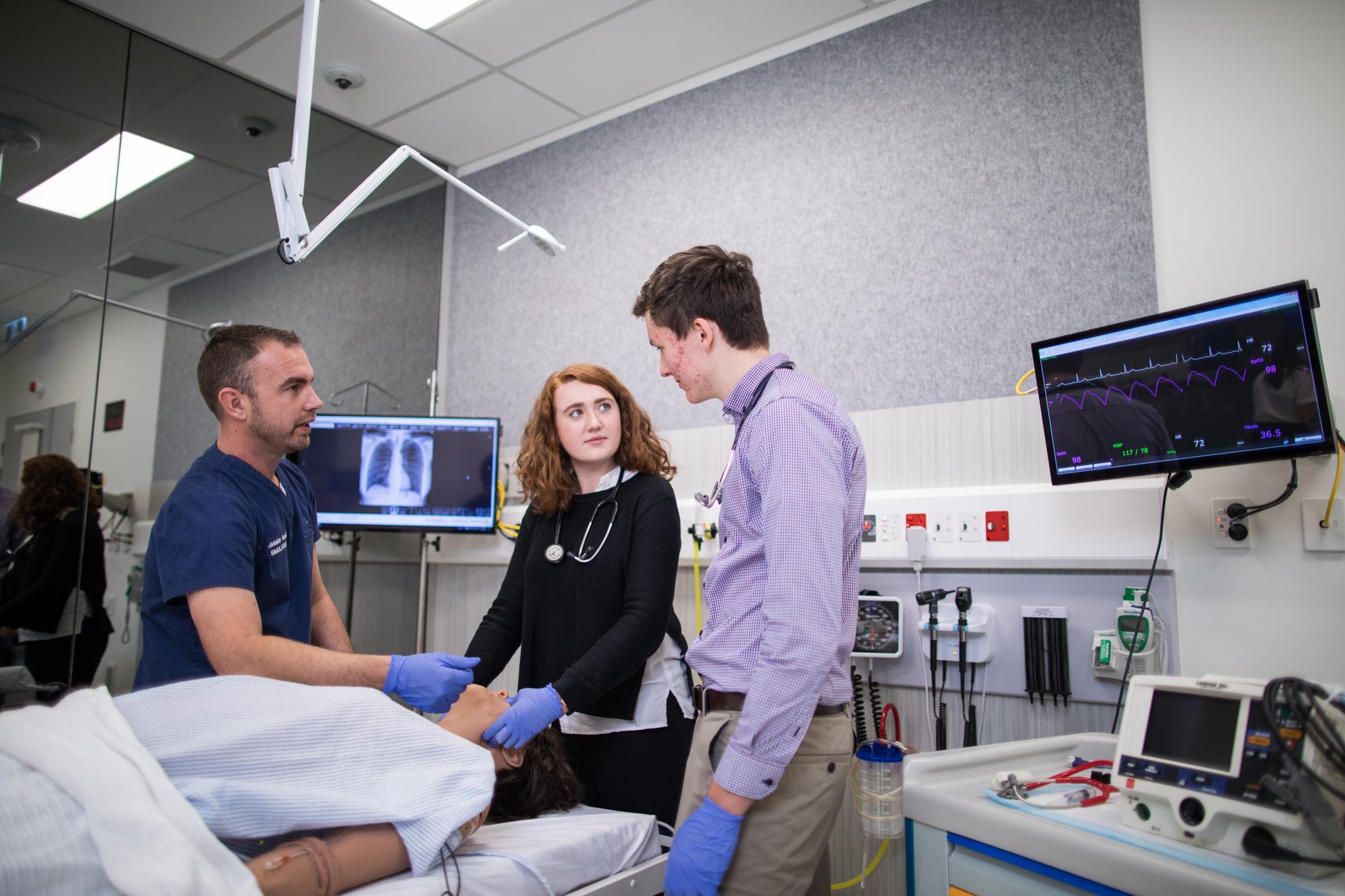 Adam Montagu with two medicine students with a simulated patient