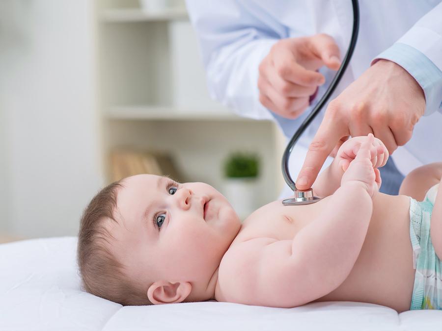 Doctor monitors baby with stethoscope
