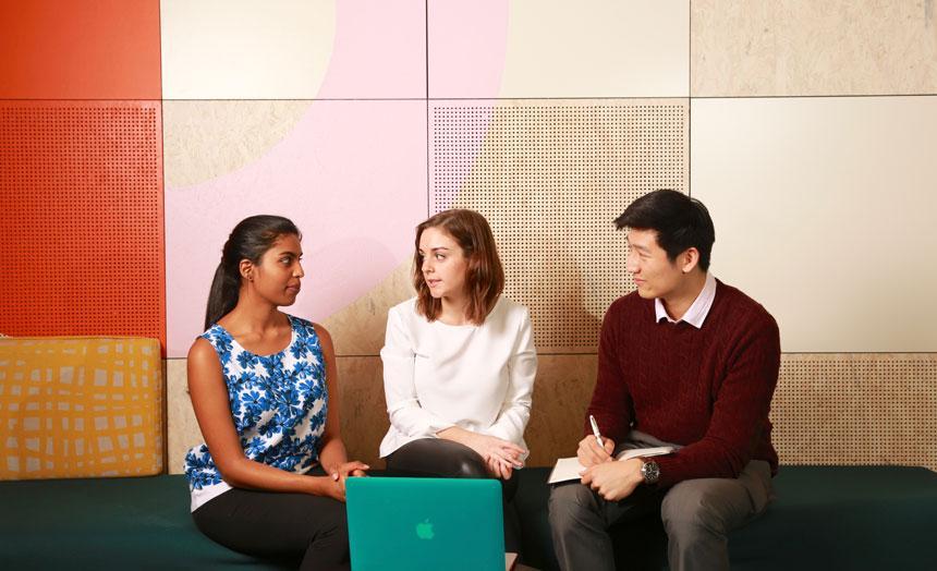 Three students sitting and chatting