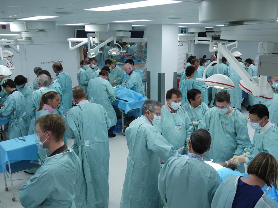 Wide angle view of lab with many people in scrubs