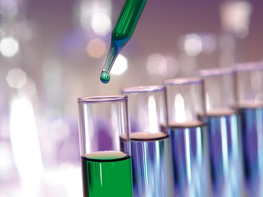 Close up of test tubes filled with green liquid