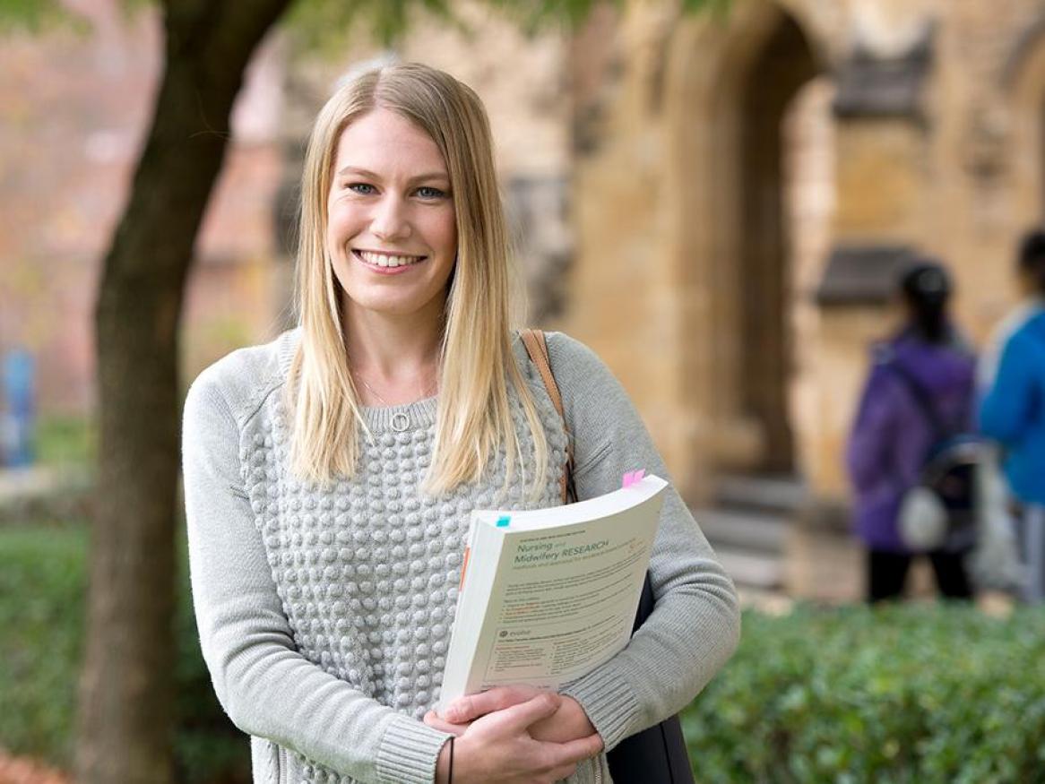 Portrait of Charlie Bell standing next to Bonython Hall