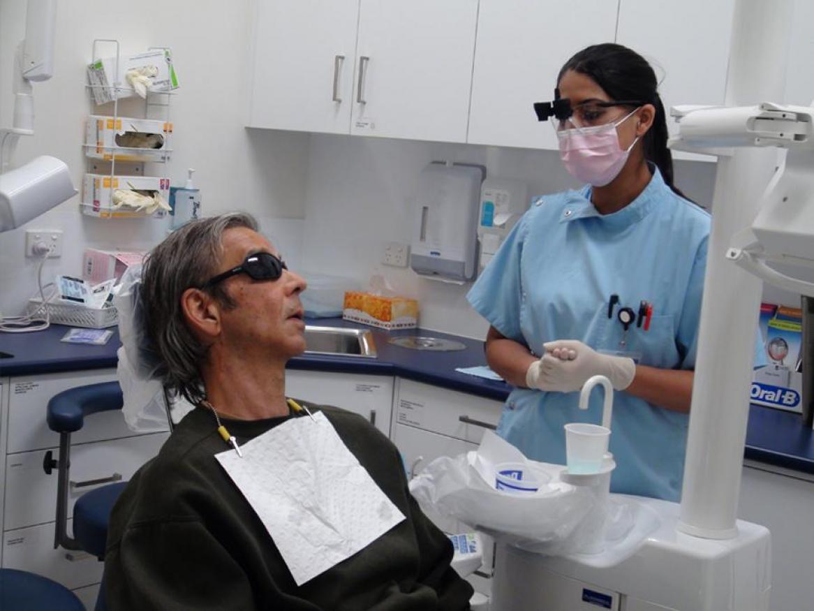 Student dentist tending to a patient