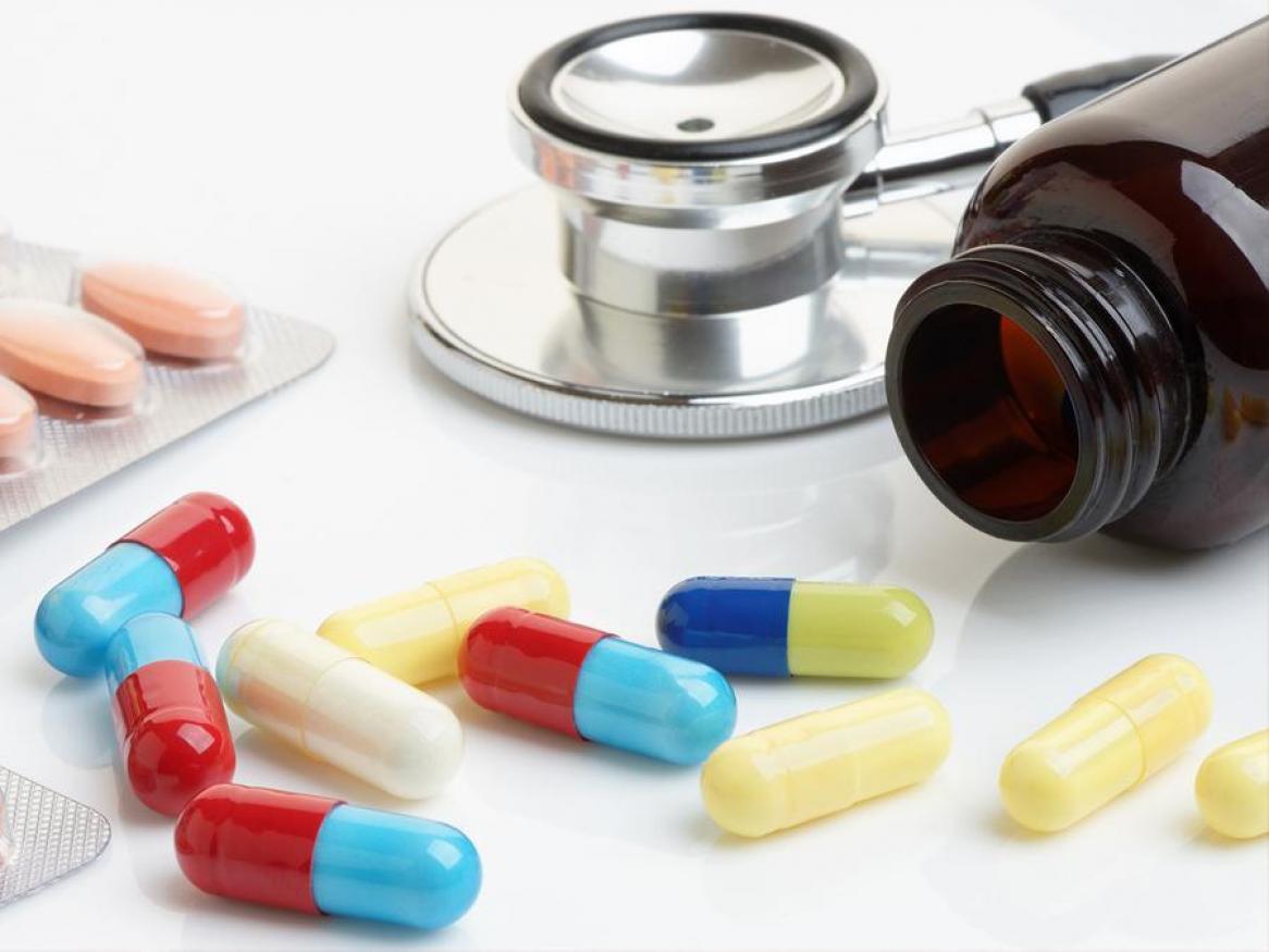 pills, capsules and medicine bottle with stethoscope